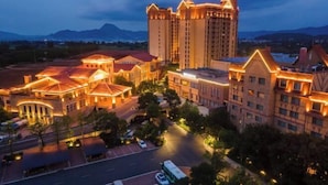 A hotel complex with multiple buildings, including a tall central tower and several smaller structures with distinct architectural styles. - Kunming Jiali Ze Saville Royal Hotel (Songming)