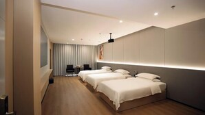 A hotel room with three beds, a desk, a chair, and a large window with curtains. - Hualong Golden Key Hotel (Songxi)