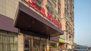 A hotel with a prominent red sign, large windows, and a covered entrance. - Pinyi Hotel (Hefei Fanhua Avenue Zhonghuancheng) (Hefei)