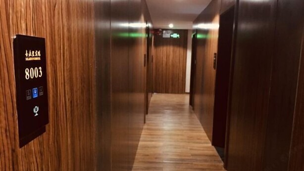 A hallway with wooden paneling and a floor number sign indicating 8003. - Sheraton Pingli Hotel (Pingli)