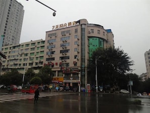 A multi-story building with signage indicating it is a hotel.