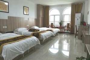 A hotel room with three beds, a desk, a chair, and a small balcony. - Zaozhuang Jingxuan Inn (Zaozhuang)