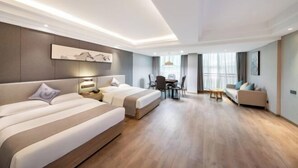 A hotel room with two beds, a desk, and a sofa. - Yayue Hotel (Yongxin Central Plaza) (Yongxin)