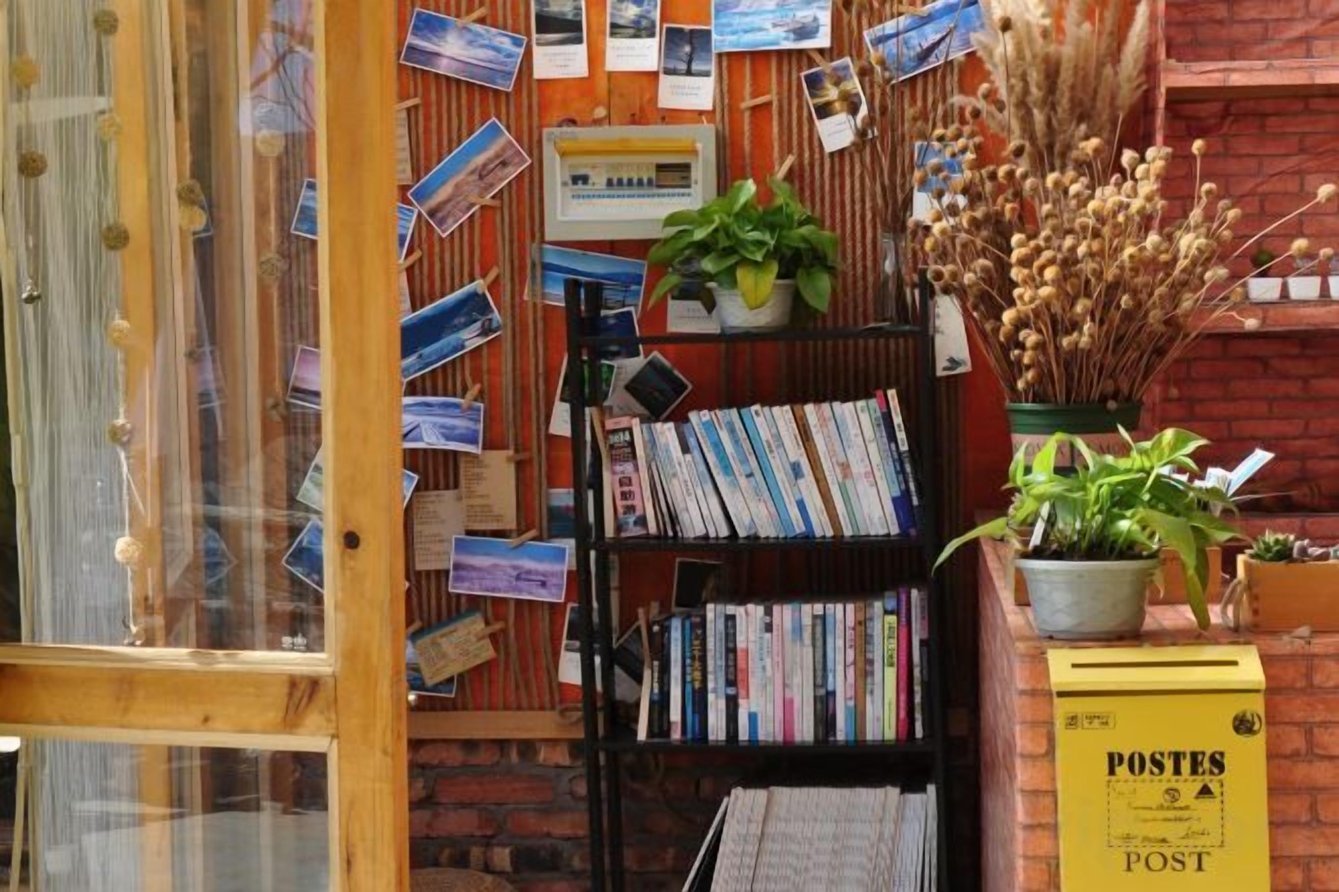 A bookstore with bookshelves, a wooden display, and a yellow sign.
