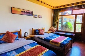 A room with two beds, wooden headboards, a painting on the wall, and a window with curtains. - Xingkong Inn (Yanyuan)