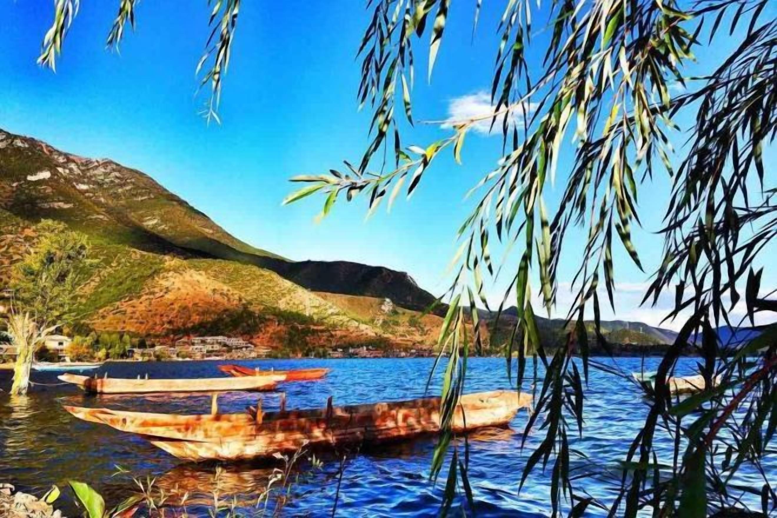 A calm lake with boats, a mountain in the background, and a clear sky.