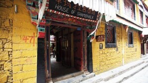 A traditional building with a sign reading "House of Shambhala." - House of Shambhala Heritage Hotel (Lhasa)