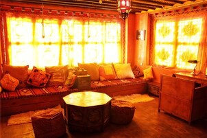 A traditional room with a sofa, a round table, and a cabinet.