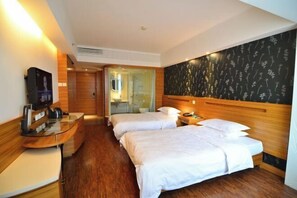 A hotel room with two beds, a wooden headboard, a glass desk, a flat-screen TV, and a bathroom visible through a glass door. - Jinyuwan Hotel (Dalian)