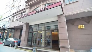 A hotel facade with a prominent "HOTEL" sign above the entrance. - Jinyuwan Hotel (Dalian)