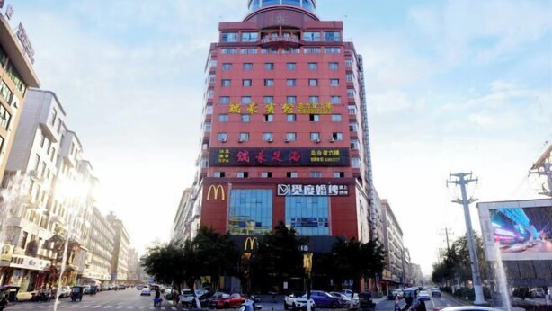 A tall hotel with multiple floors, featuring a prominent McDonald's sign on the ground floor. - Ruihao Hotel (Pingyang)
