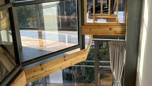 A modern interior with a large window, wooden beams, and a curtain. - Hongcun Huifeng Yayun Hotel (Yi County)