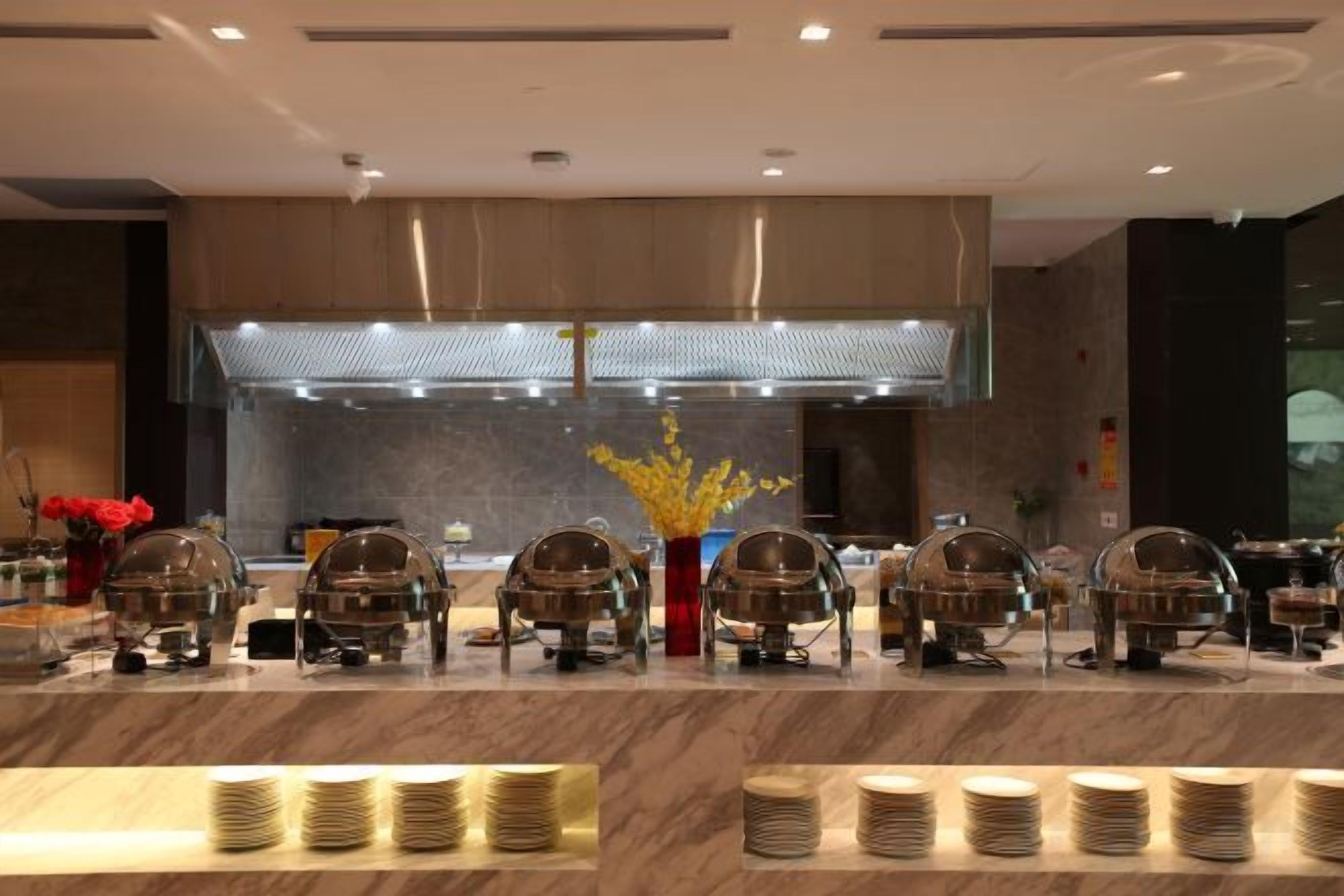 A buffet setup with multiple serving stations and a central food display.
