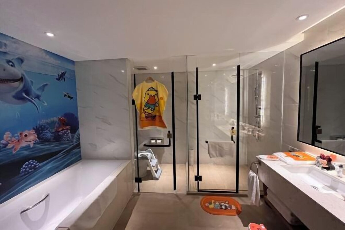 A modern bathroom with a large bathtub, a glass shower enclosure, and a vanity with a mirror.