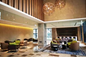 A spacious lobby with modern seating, a high ceiling, and a large chandelier. - Shanghai Hongzhu Garden Hotel (Shanghai)