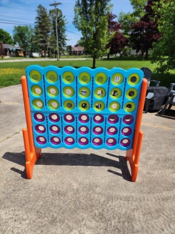 A blue and orange stand with circular slots, likely for holding items.