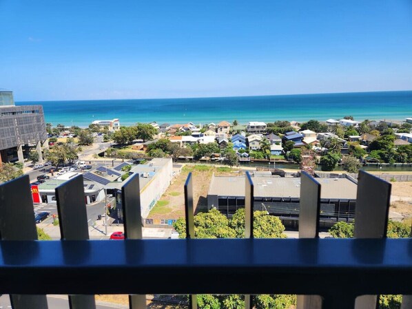 A coastal town with a view of the ocean, residential buildings, and a McDonald's restaurant.