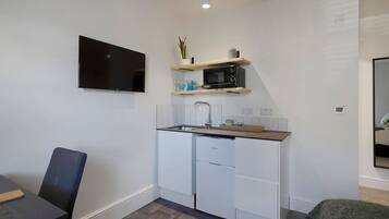 Fridge, microwave, coffee/tea maker, cookware/dishes/utensils