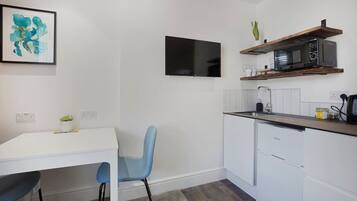 Fridge, microwave, coffee/tea maker, cookware/dishes/utensils