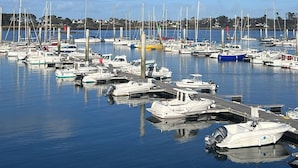 A marina with various boats docked, calm water, and a clear blue sky. - Pretty Breton house with sea view near the beaches and port of Aber Wrach (Landéda)