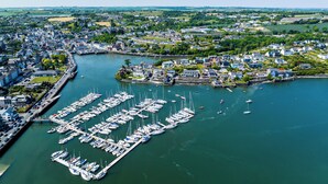 An aerial view of a coastal town with a marina filled with boats, surrounded by residential buildings and greenery. - 17 Shearwater overlooking Kinsale Harbour (Kinsale)