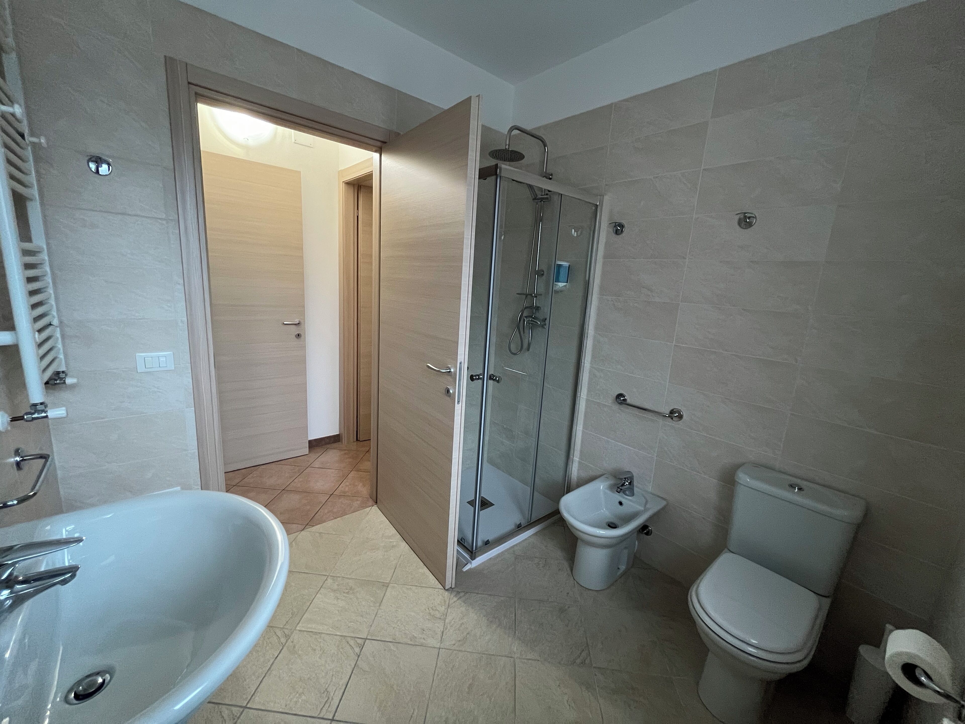 A bathroom with a bathtub, a shower, a bidet, and a toilet.