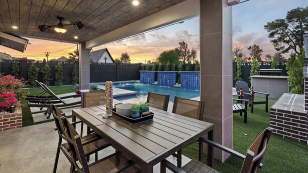 An outdoor patio with a pool, wooden ceiling, and seating area. - Walk to Old Town | Pool • Hot Tub • EV Charger (Scottsdale)