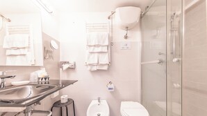 A modern bathroom with a sink, bidet, toilet, and glass-enclosed shower. - Room-skylight Double Room in History Hou (Rome)