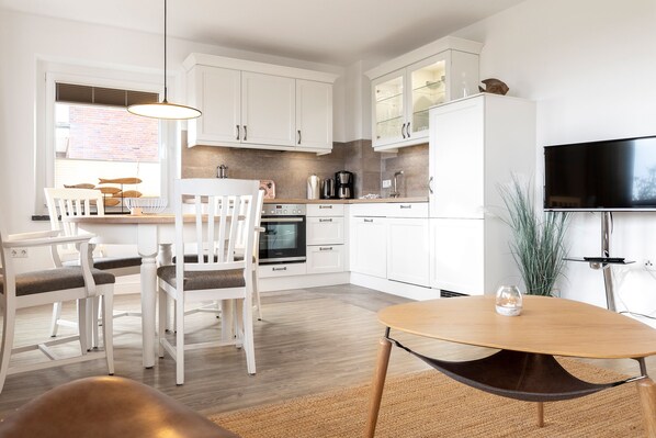 Enjoy meals in the kitchen with an oven and coffee maker, and dine at the round table.