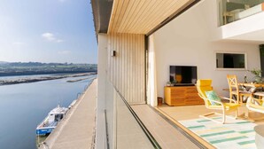 A balcony with a view of a river and a boat dock. - Clearwater House - sleeps 6 guests  in 3 bedrooms (Hayle)