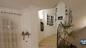 A staircase with a handrail, a small potted plant, and a rug on the floor. - VILLA WITH PRIVATE POOL  (Hurghada)