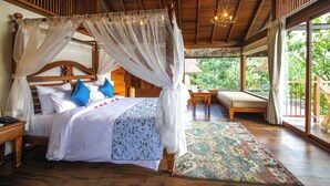 A four-poster bed with a canopy, a wooden headboard, and a bedside table with a lamp. - Toyam by Orchid Hotels (Bhor)