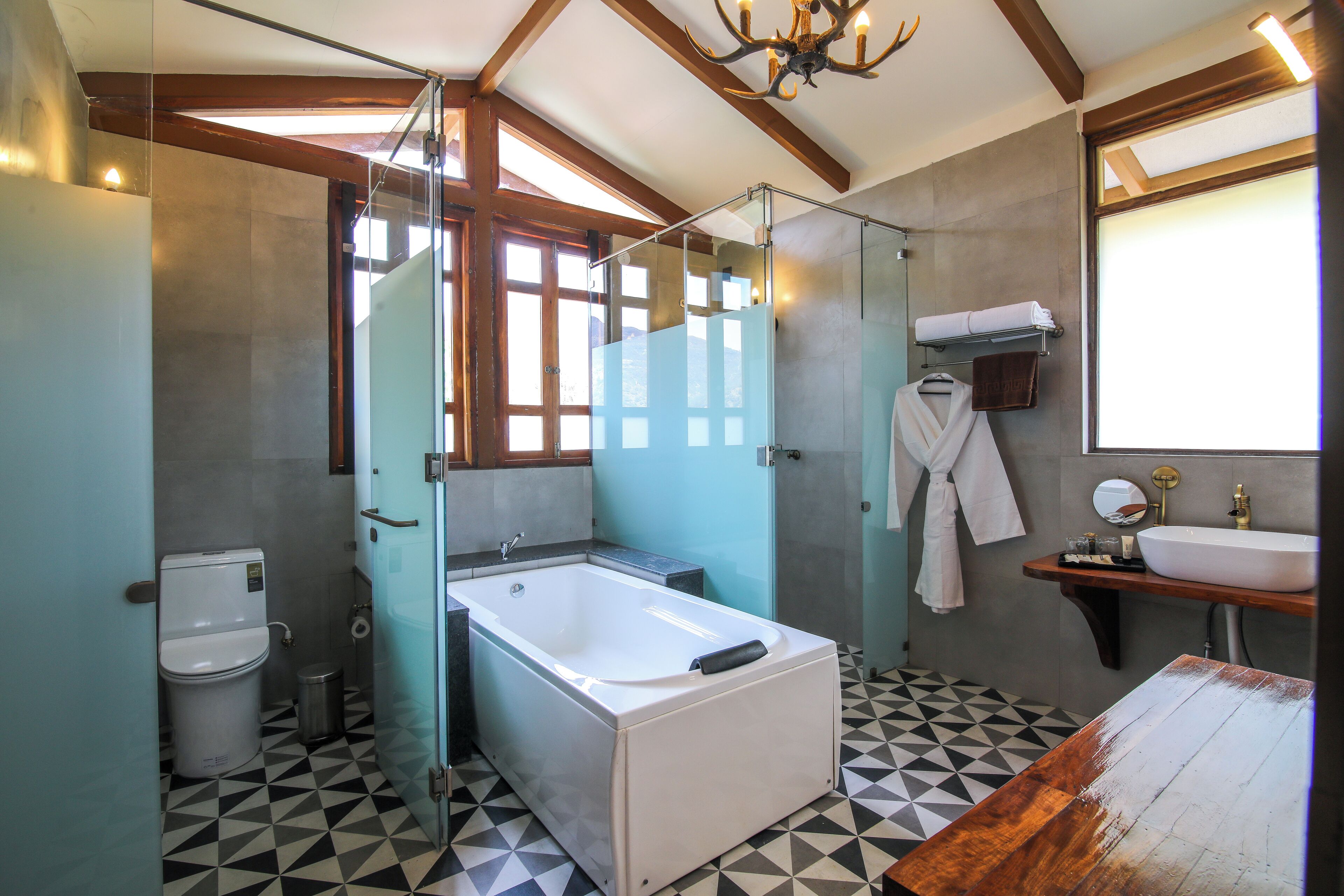 A bathroom with a glass-enclosed shower, a white bathtub, a sink, and a mirror.