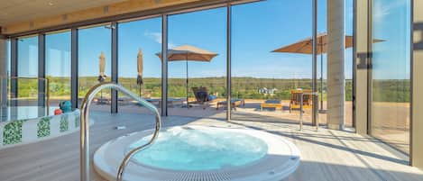 Indoor pool, pool umbrellas, pool loungers