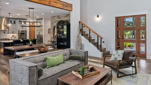 A spacious living area with a modern kitchen, a staircase, and a dining area. - Suncadia's Best Kept Secret | Experience Luxury @ Great Rates (Cle Elum)