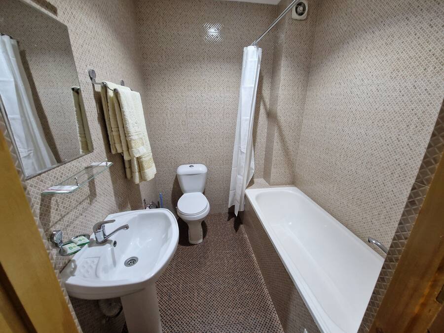 A bathroom with a sink, toilet, and bathtub.