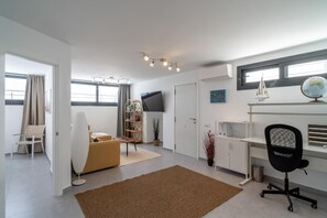 Relax in a comfortable seating area with a sofa and armchairs, perfect for unwinding.