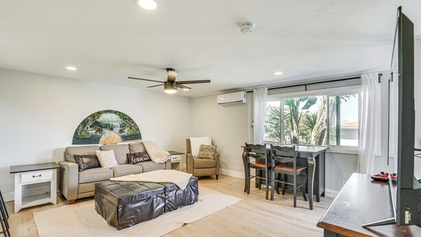 A modern living room with a sofa, ottoman, dining table, and chairs. - San Diego Apartment w/ Patio - Near Balboa Park! (San Diego)