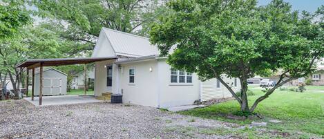 A single-story house with a covered porch, a garage, and a well-maintained lawn.