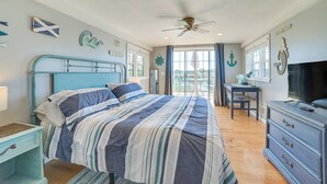 A bedroom with a bed, a desk, a television, and nautical-themed decor. - Riverfront Cheboygan Home w/ Dock ~ 4 Mi to Town! (Cheboygan)