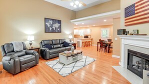 A spacious living room with a fireplace, leather sofas, and a dining area. - Cozy Hermitage Home w/ Deck: 11 Mi to Nashville! (Hermitage)