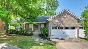 A two-story house with a brick exterior, a front garage, and a well-maintained lawn. - Cozy Hermitage Home w/ Deck: 11 Mi to Nashville! (Hermitage)