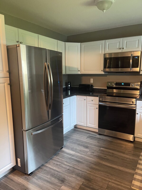 Enjoy cooking in this fully equipped kitchen with a refrigerator, microwave, and oven.