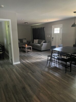 Relax in this inviting living area with a sofa, dining table, and ample space for gatherings.