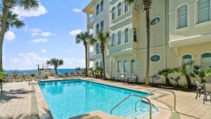 A rectangular swimming pool with a no diving sign, surrounded by lounge chairs and palm trees, adjacent to a multi-story building with balconies and large windows. - ☀️Beachfront 30A Penthouse with Incredible Views-Endless Sea☀️ (Santa Rosa Beach)