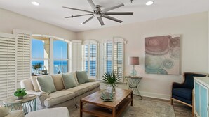 A living room with a sofa, coffee table, and a ceiling fan. - ☀️Beachfront 30A Penthouse with Incredible Views-Endless Sea☀️ (Santa Rosa Beach)