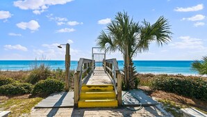 A wooden boardwalk leading to a beach with a clear blue sky and palm trees. - ☀️Beachfront 30A Penthouse with Incredible Views-Endless Sea☀️ (Santa Rosa Beach)