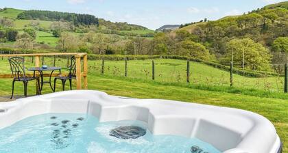 A lovely glamping pod, with a private hot tub, overlooking the rolling hills.