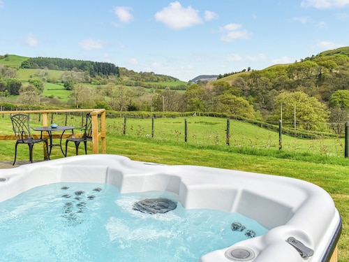 A lovely glamping pod, with a private hot tub, overlooking the rolling hills.