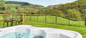 A lovely glamping pod, with a private hot tub, overlooking the rolling hills.